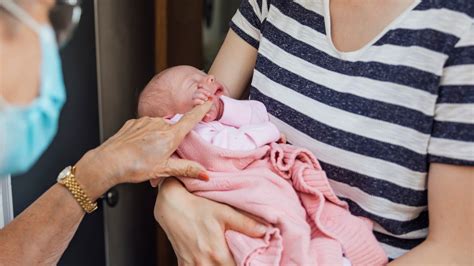 Obrázok matky jemne kúpacej svoje novorodeniatko s láskou